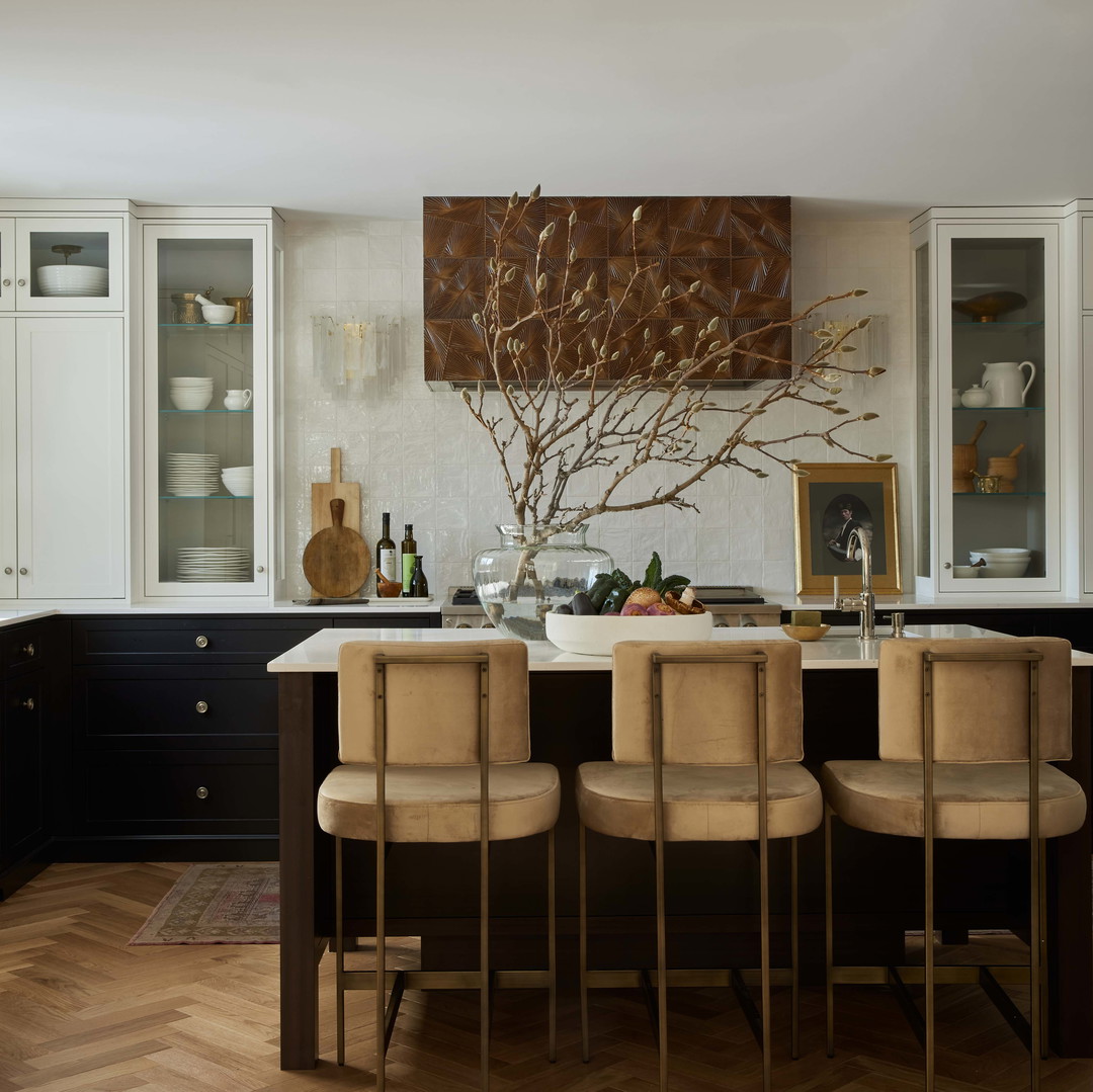 a kitchen with a table and chairs and a painting on the wall