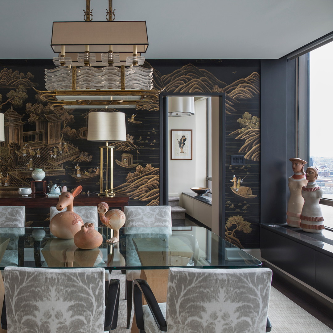 a dining room with a glass table and chairs