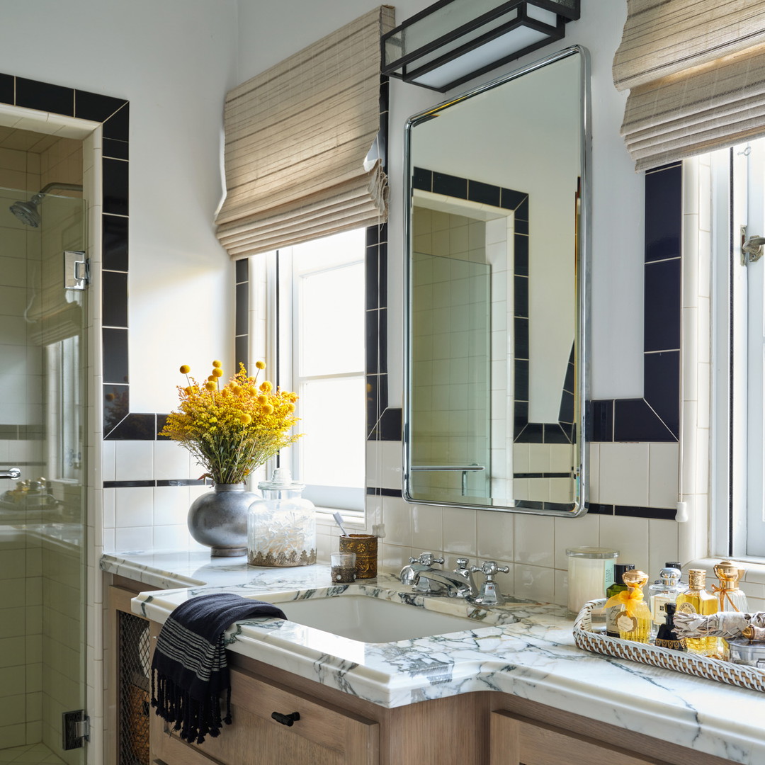 a bathroom with two sinks and a large mirror