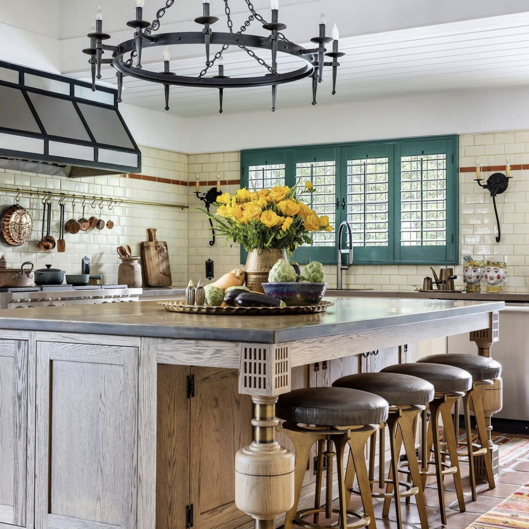 a kitchen with a center island with stools