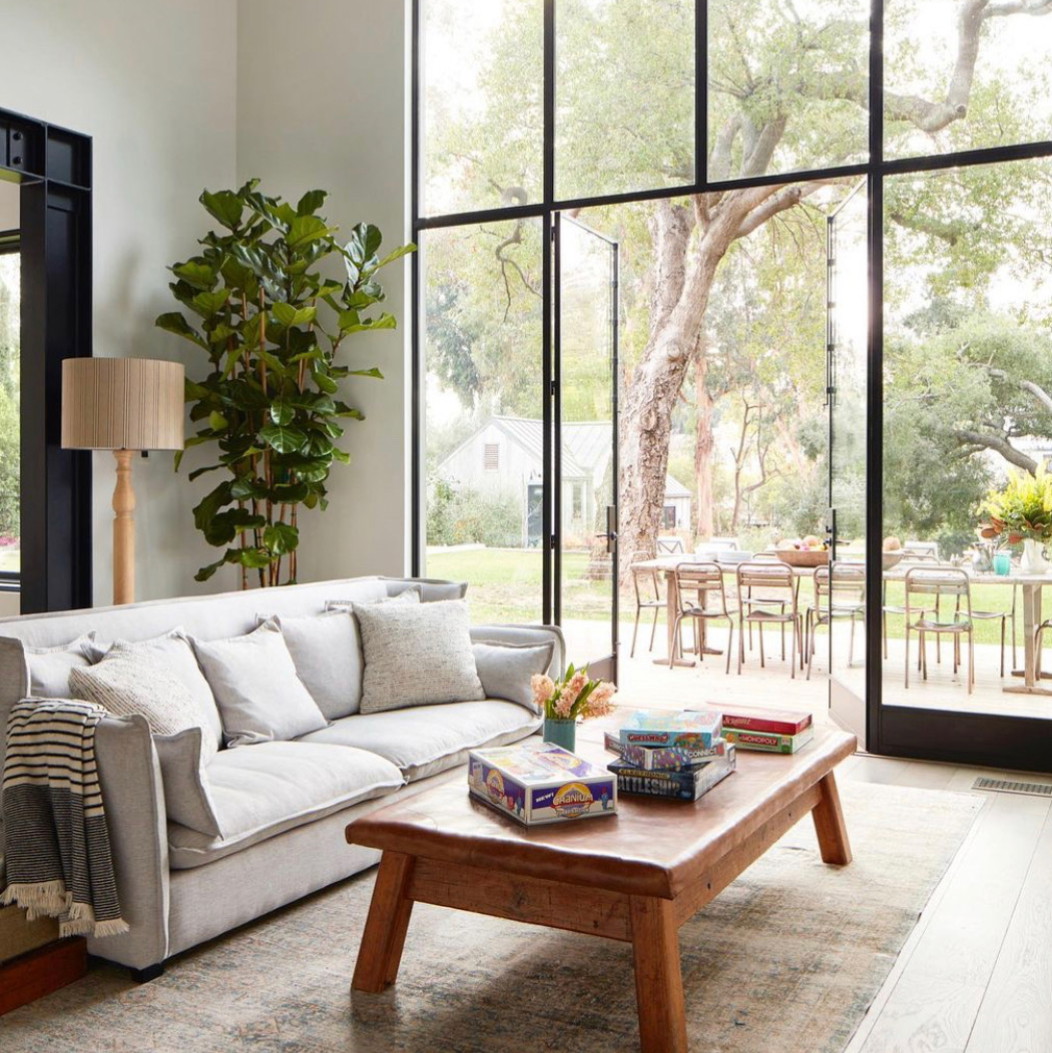 a living room filled with furniture and a large window