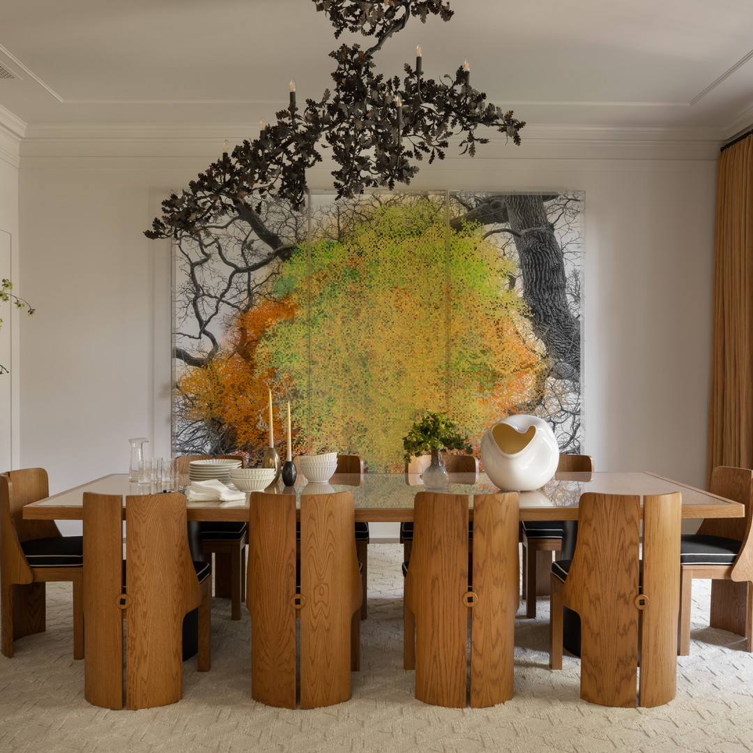 a dining room with a large painting on the wall