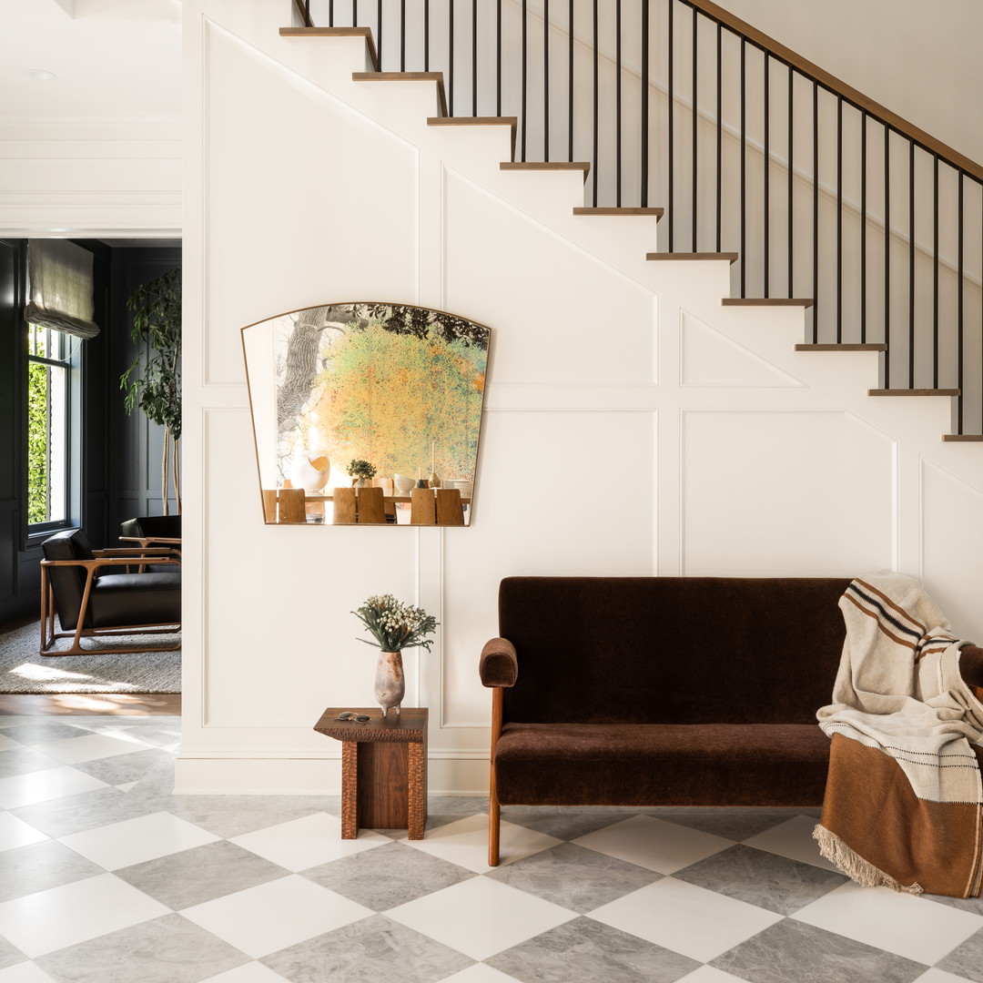 a living room with a couch a table and a stair case