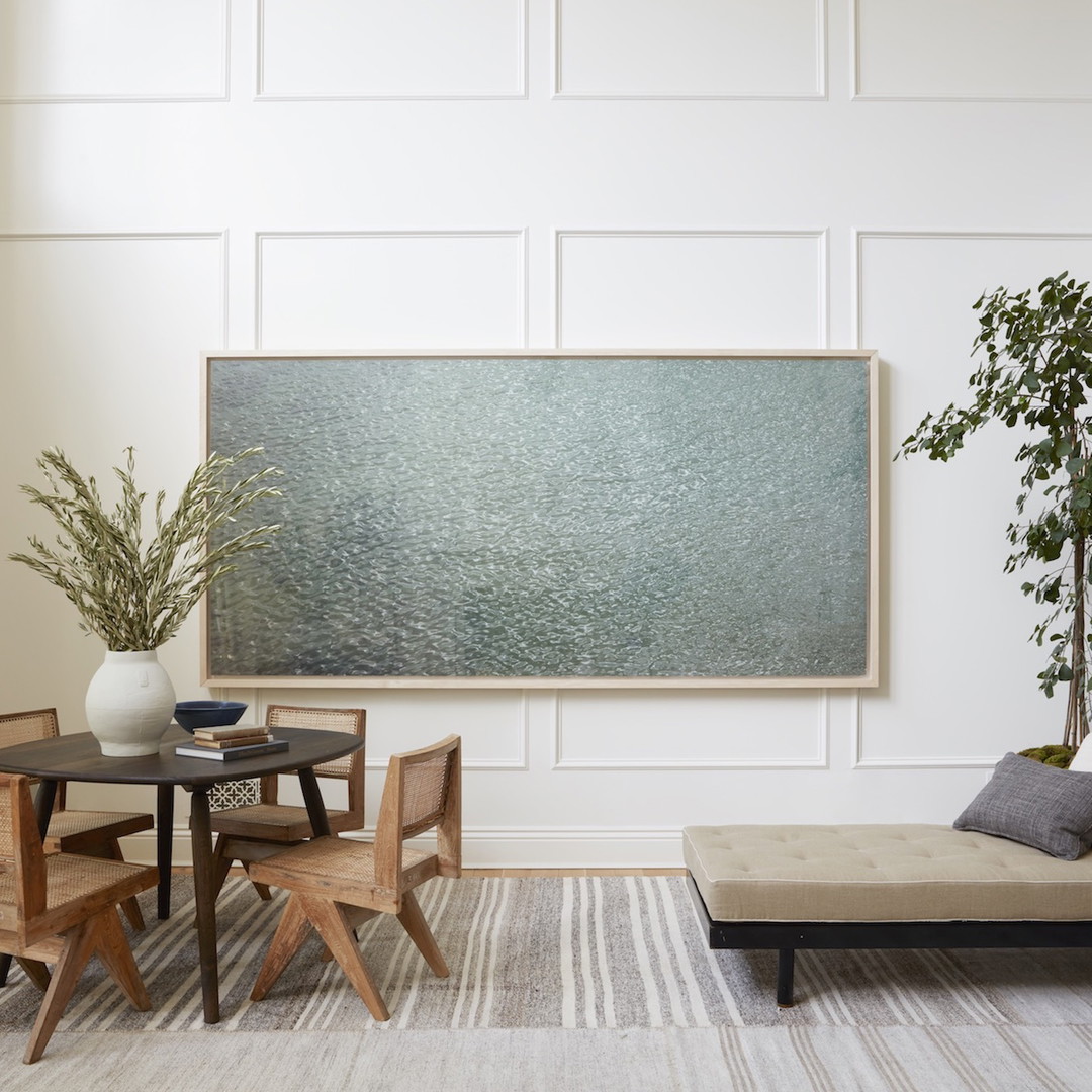 a living room filled with furniture and a painting on the wall