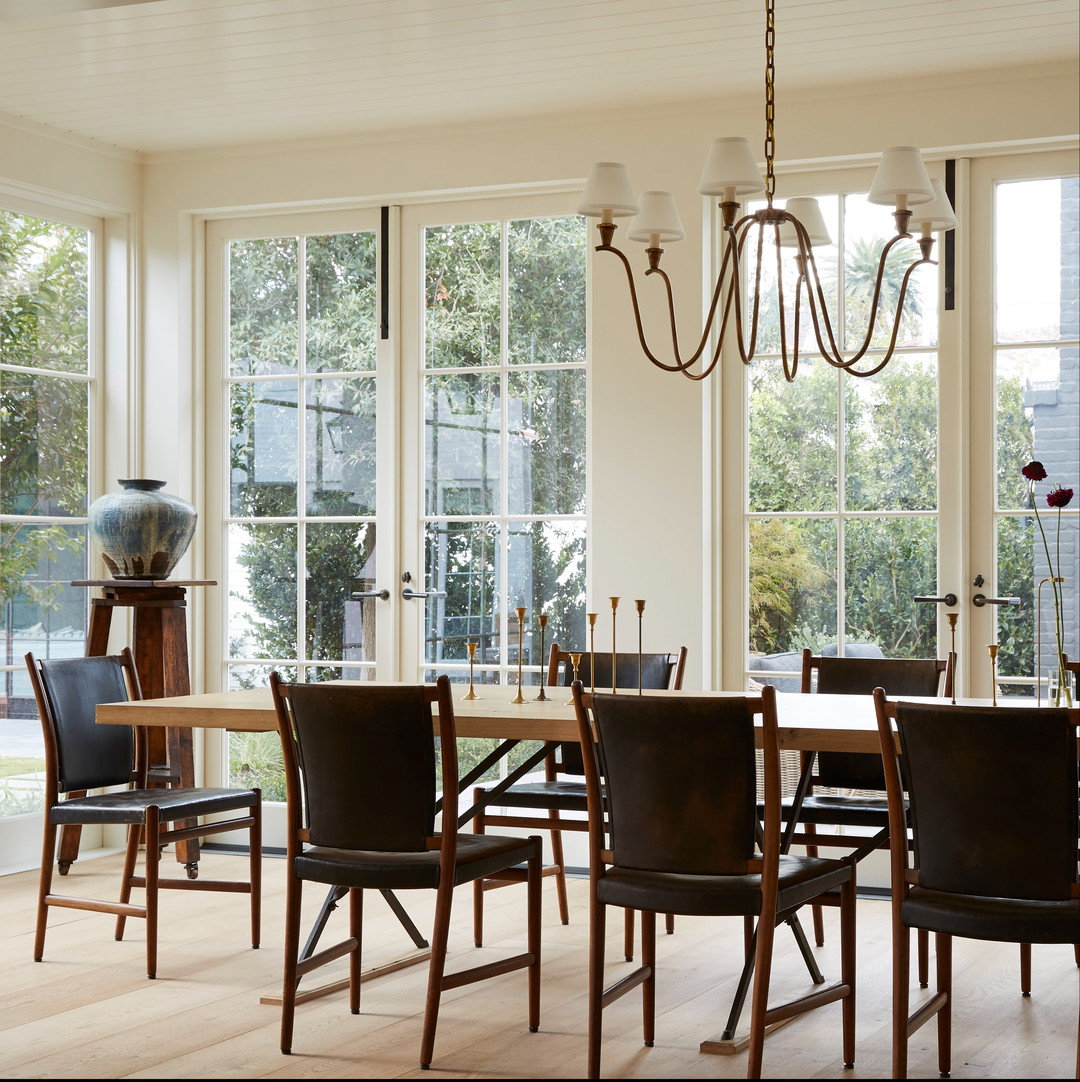 a dining room table with chairs and a chandelier