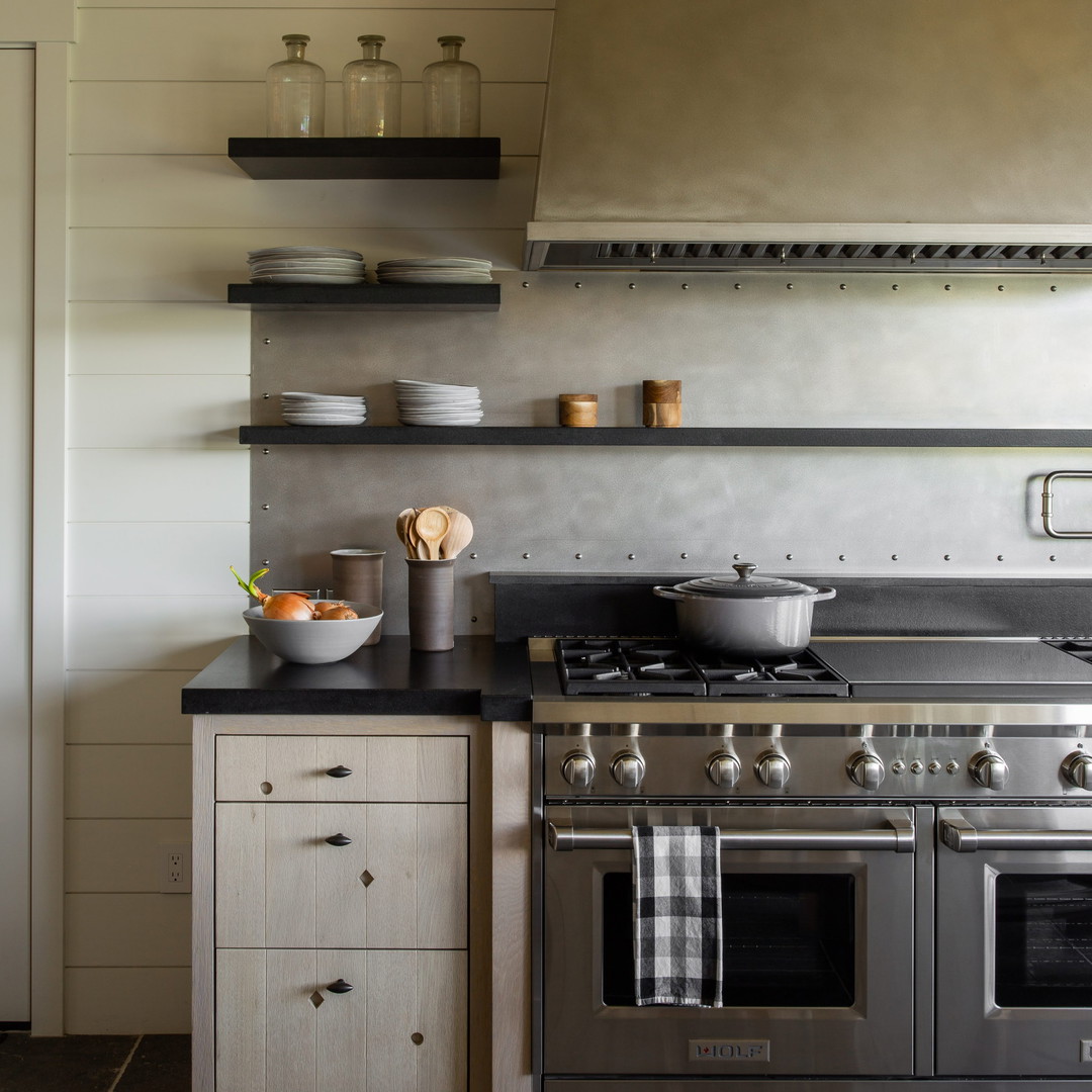 a stove top oven sitting inside of a kitchen