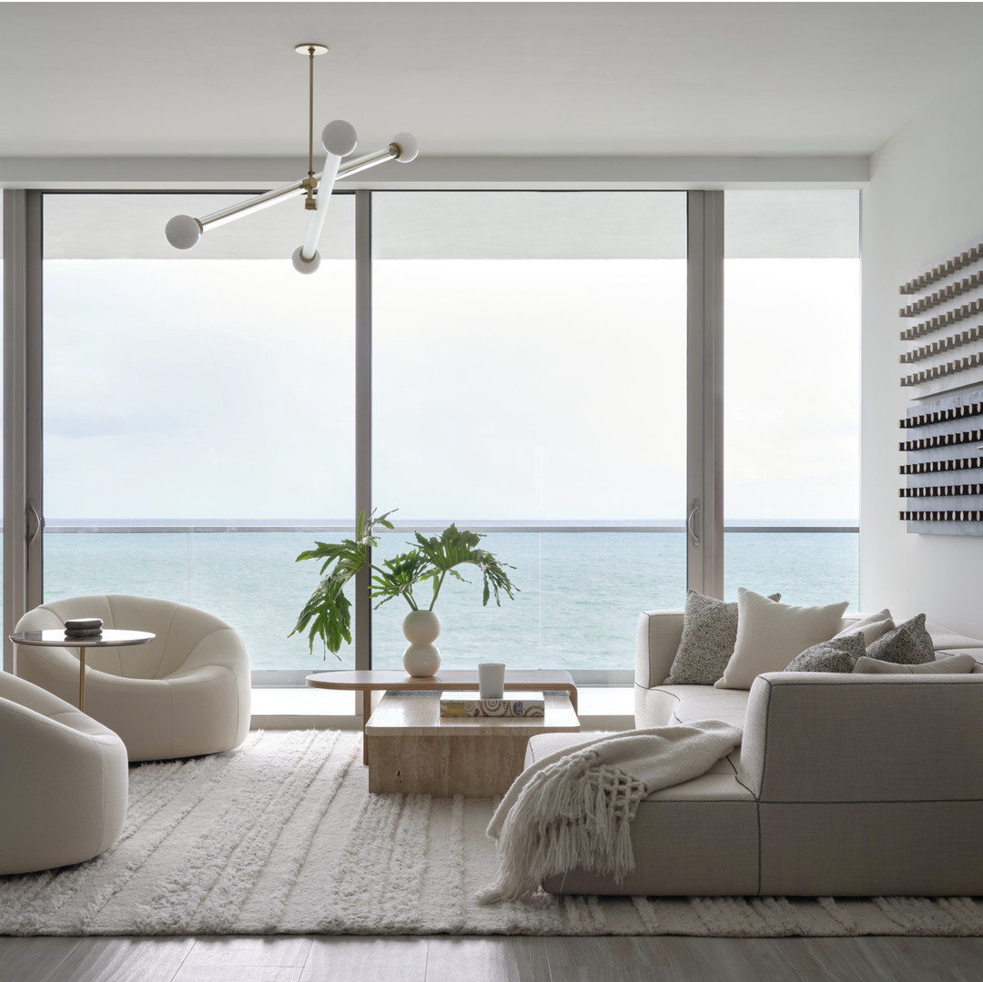 a living room with a view of the ocean