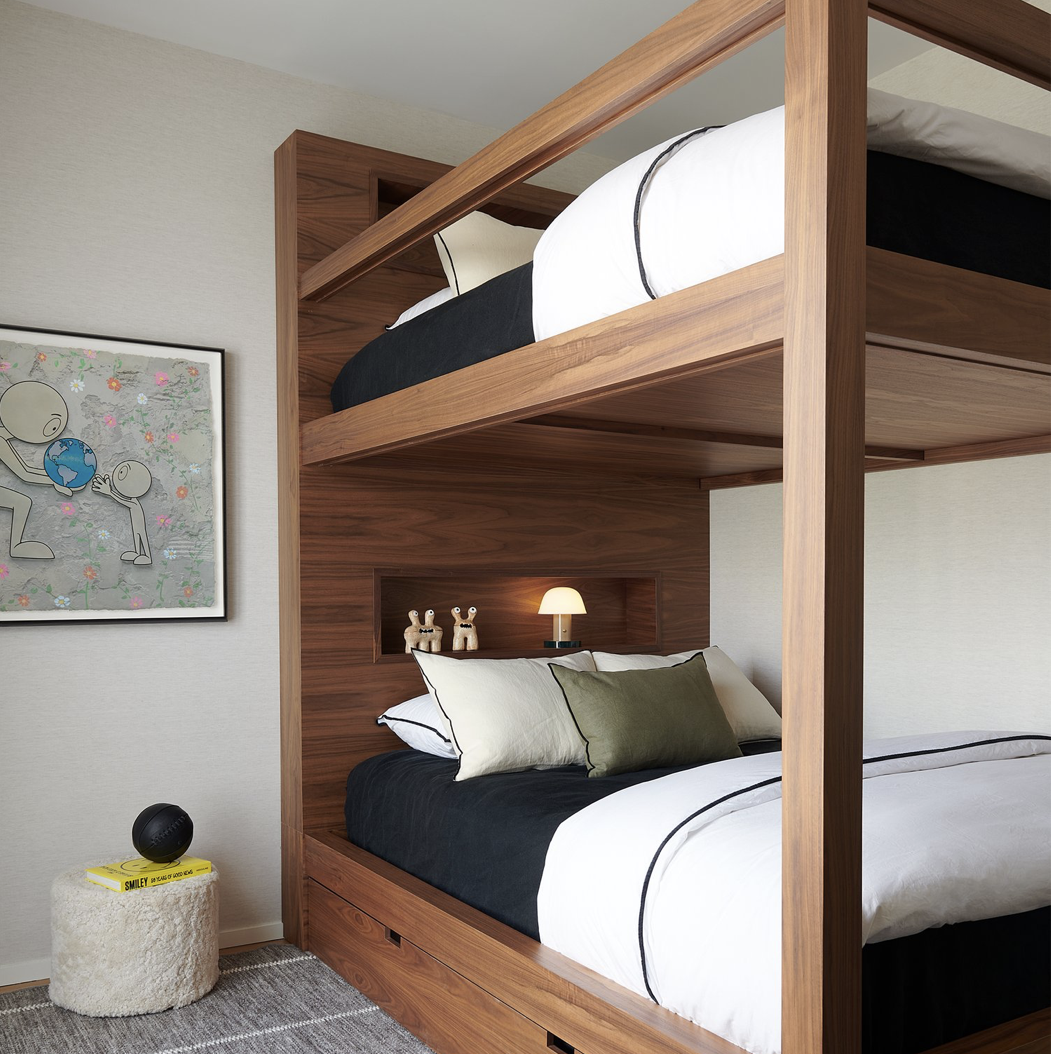 a bedroom with a bunk bed and a night stand