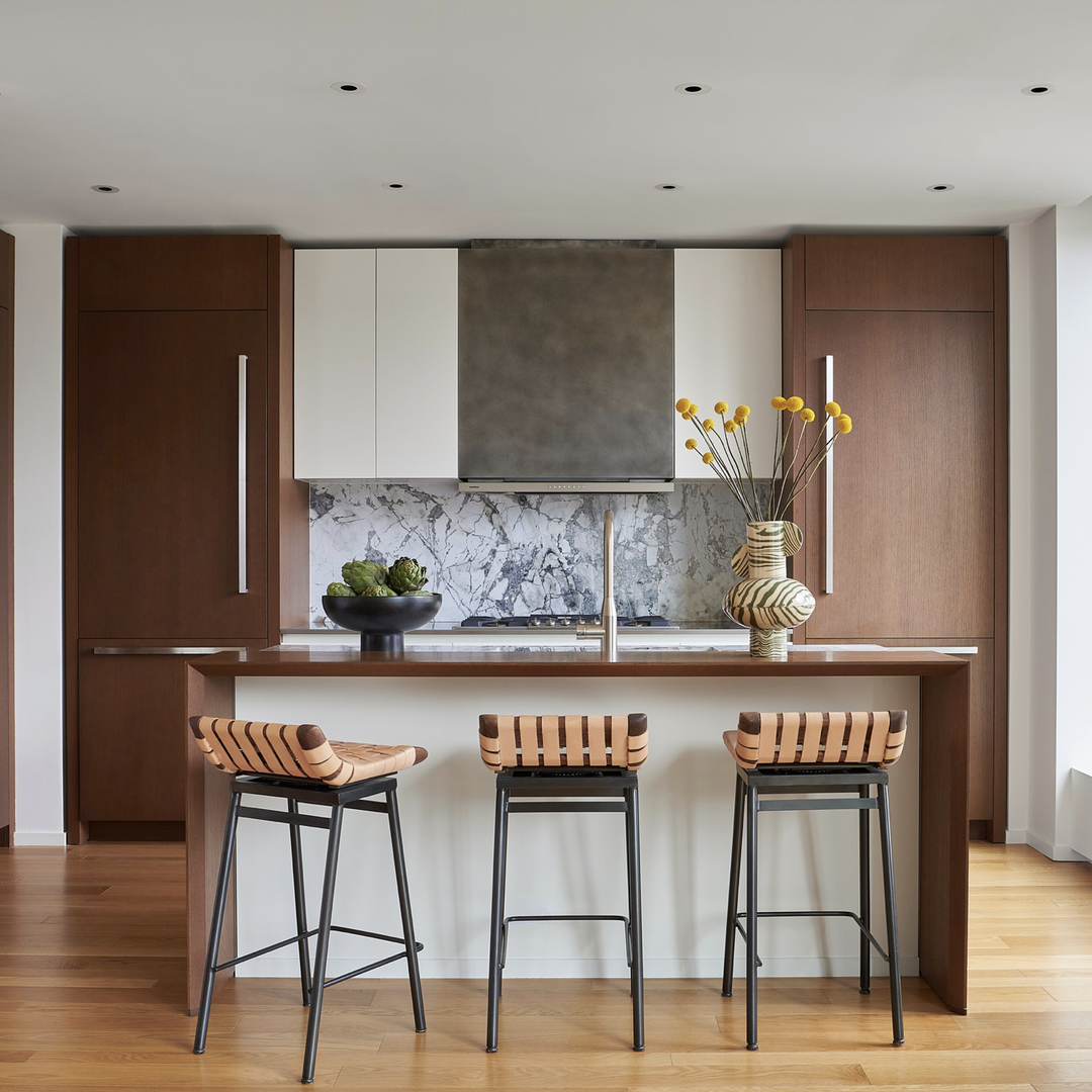 a kitchen with two stools and a center island