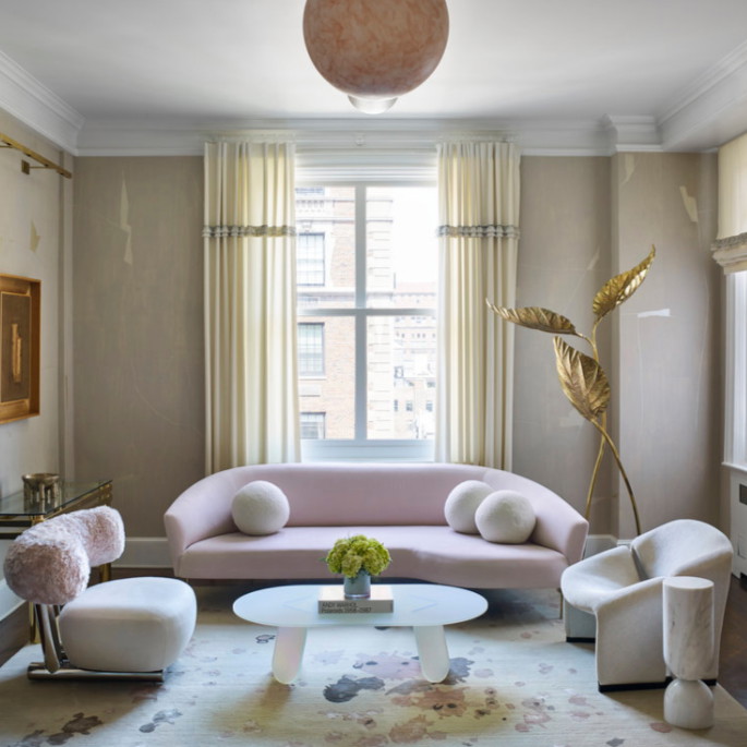 a living room filled with furniture and a large window