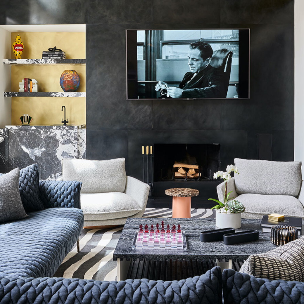 a living room filled with furniture and a flat screen tv