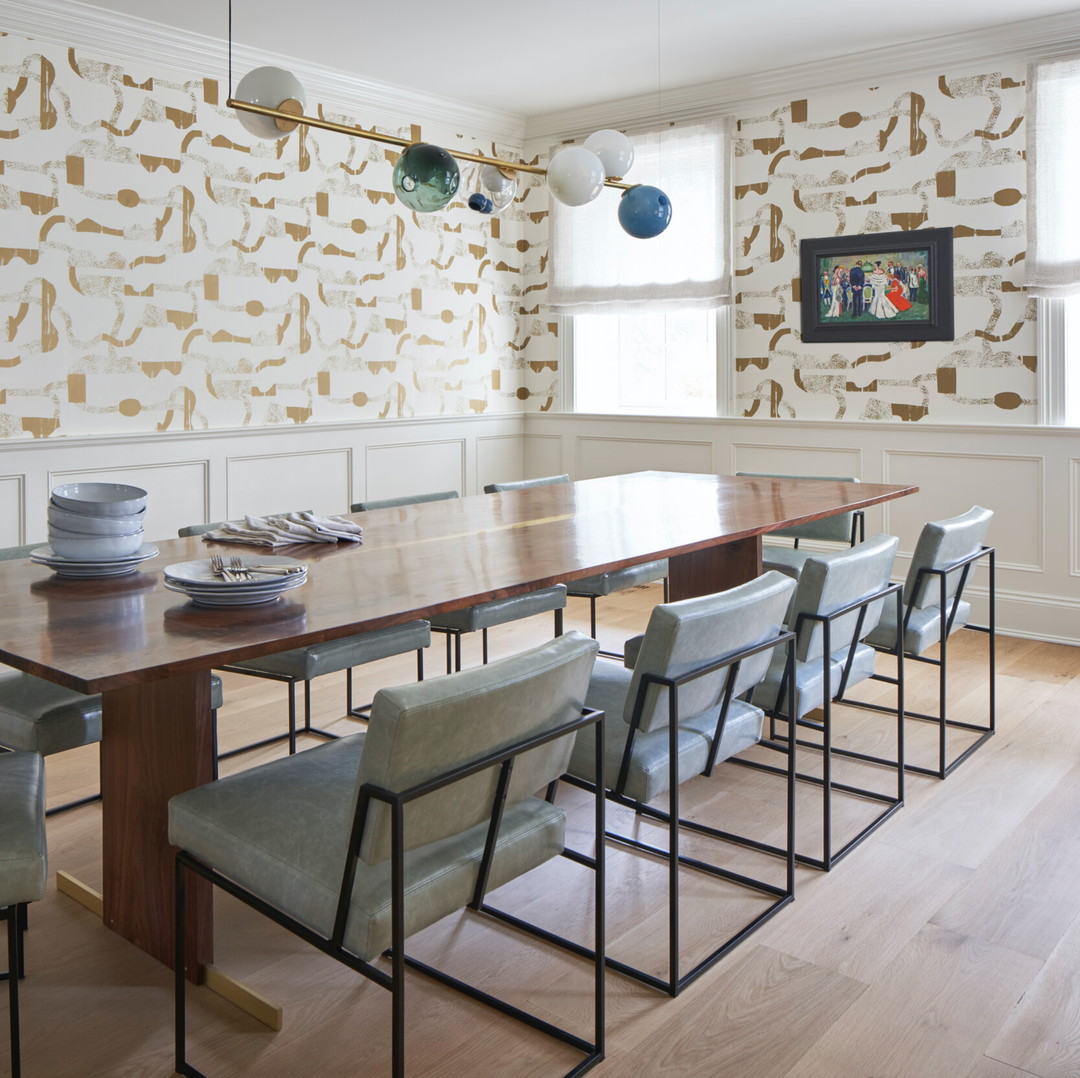 a dining room with a long table and chairs