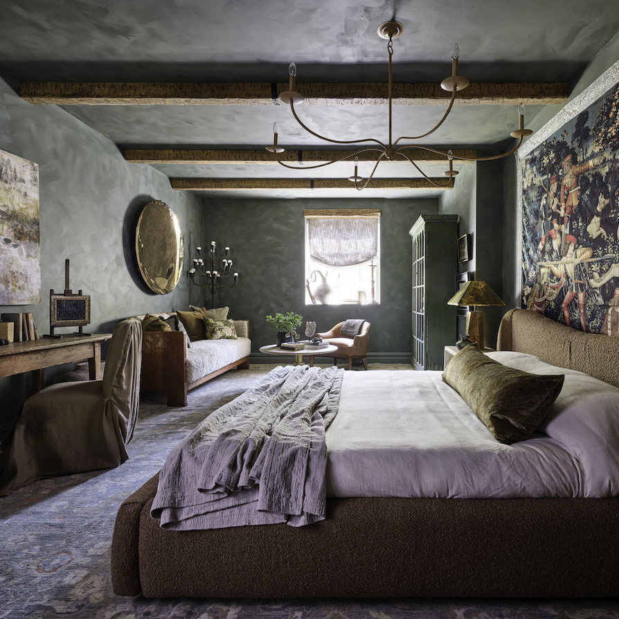 a bedroom with a large bed and a painting on the wall