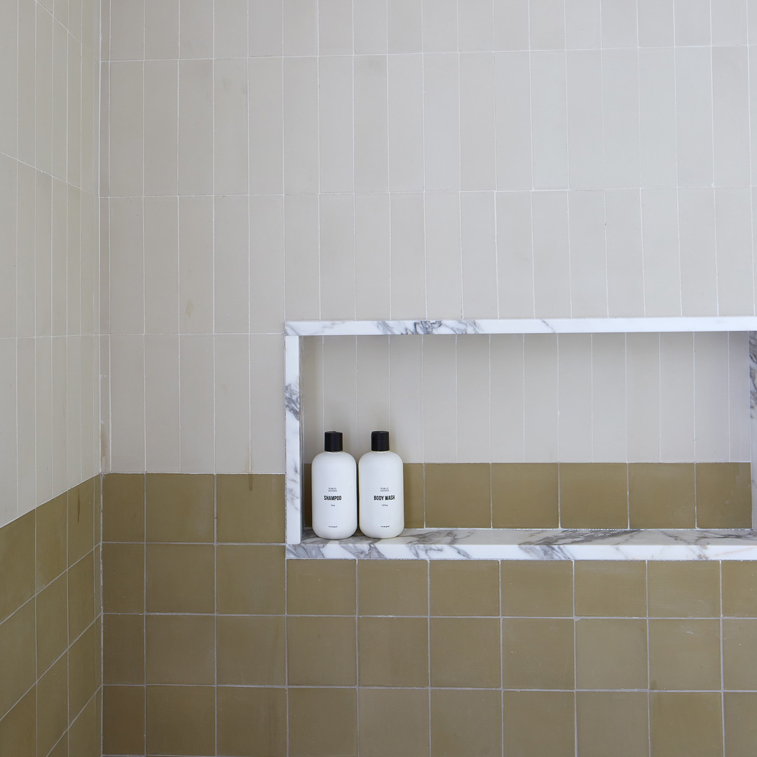 a bathroom with two bottles of soap on a shelf