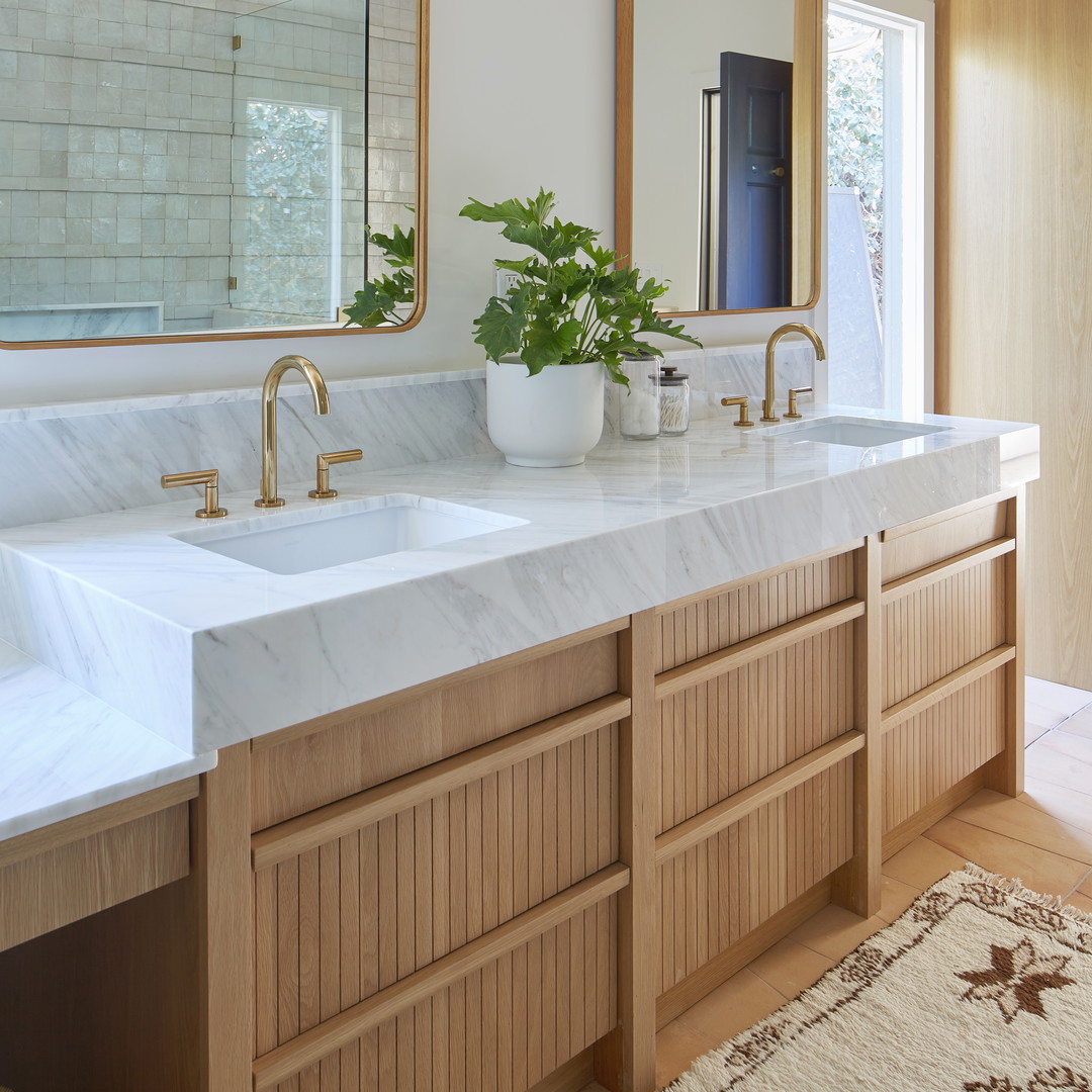 a bathroom with two sinks and a large mirror