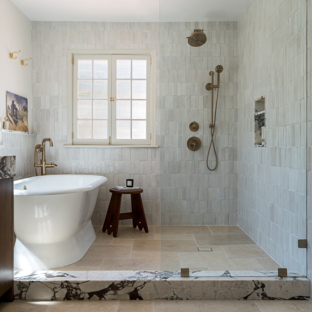 a bathroom with a large tub and a walk in shower