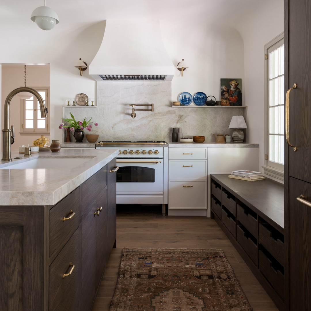 a kitchen with a rug in the middle of the floor