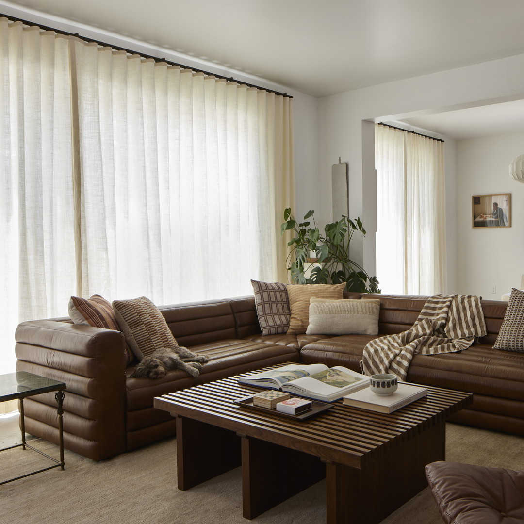 a living room filled with furniture and a large window