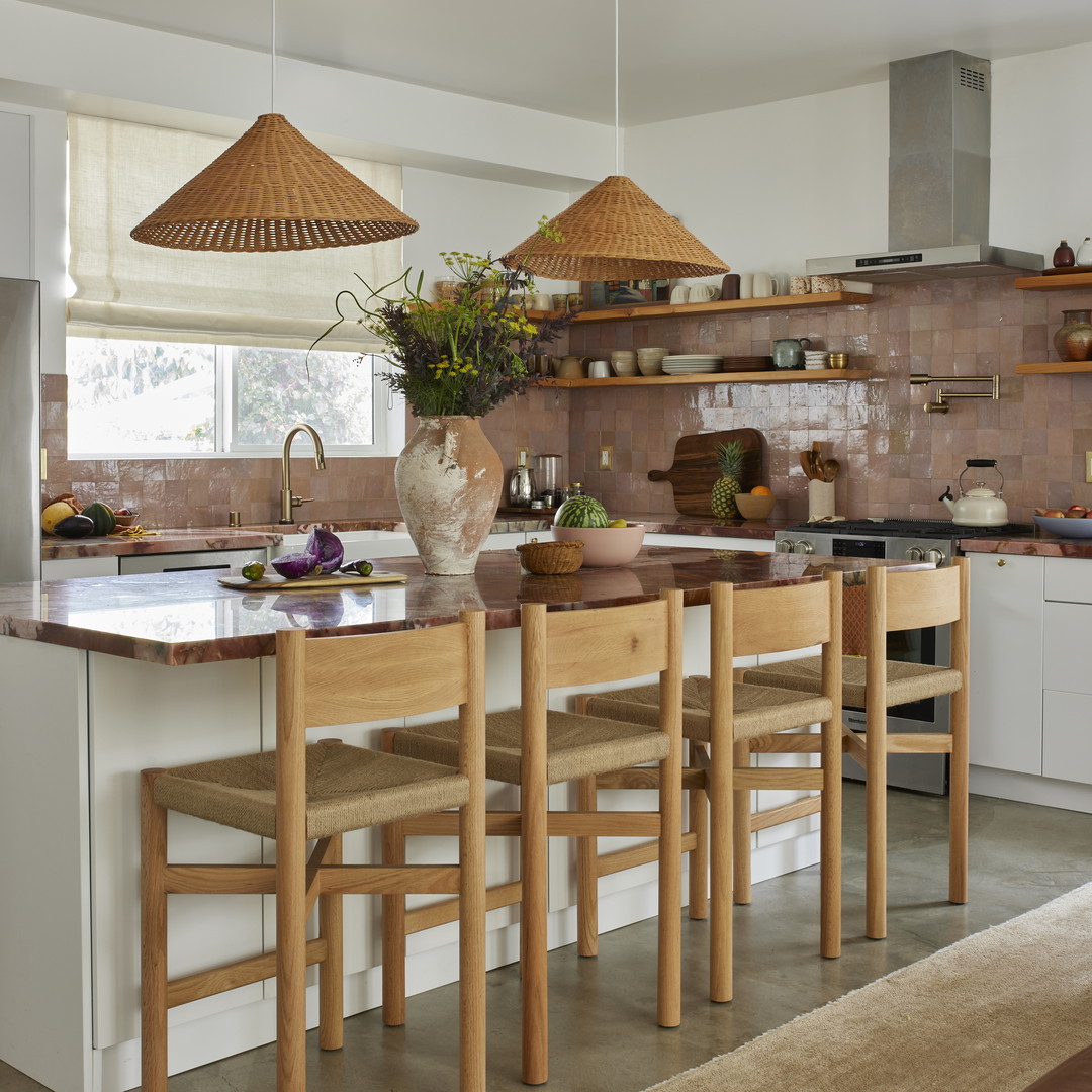 a kitchen with a center island with chairs