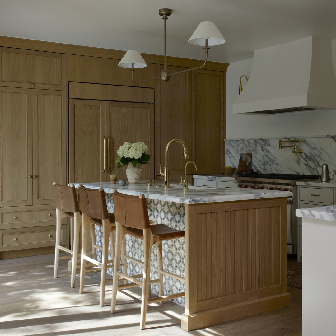 a kitchen with a marble counter top and wooden cabinets