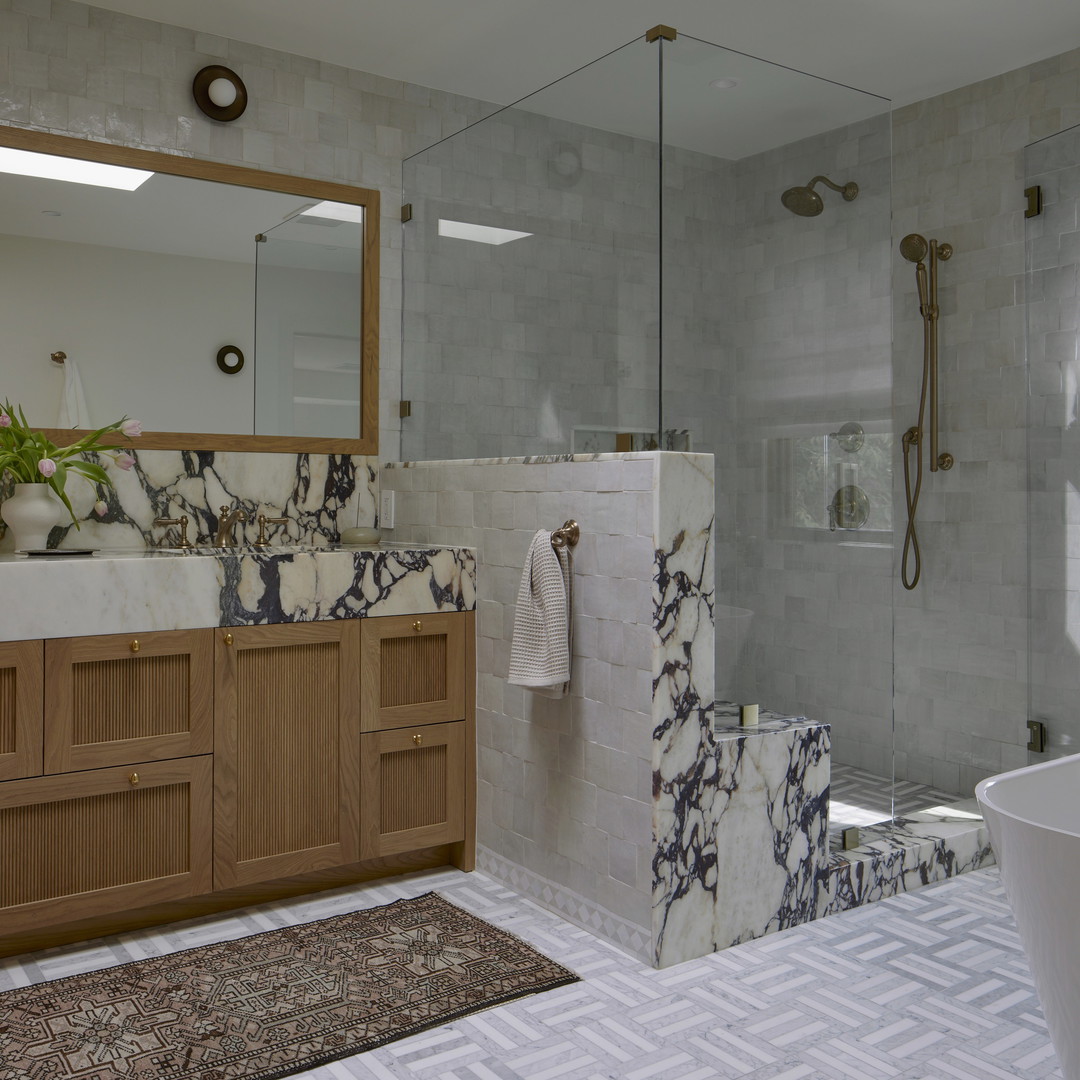 a bathroom with a sink, toilet, and shower