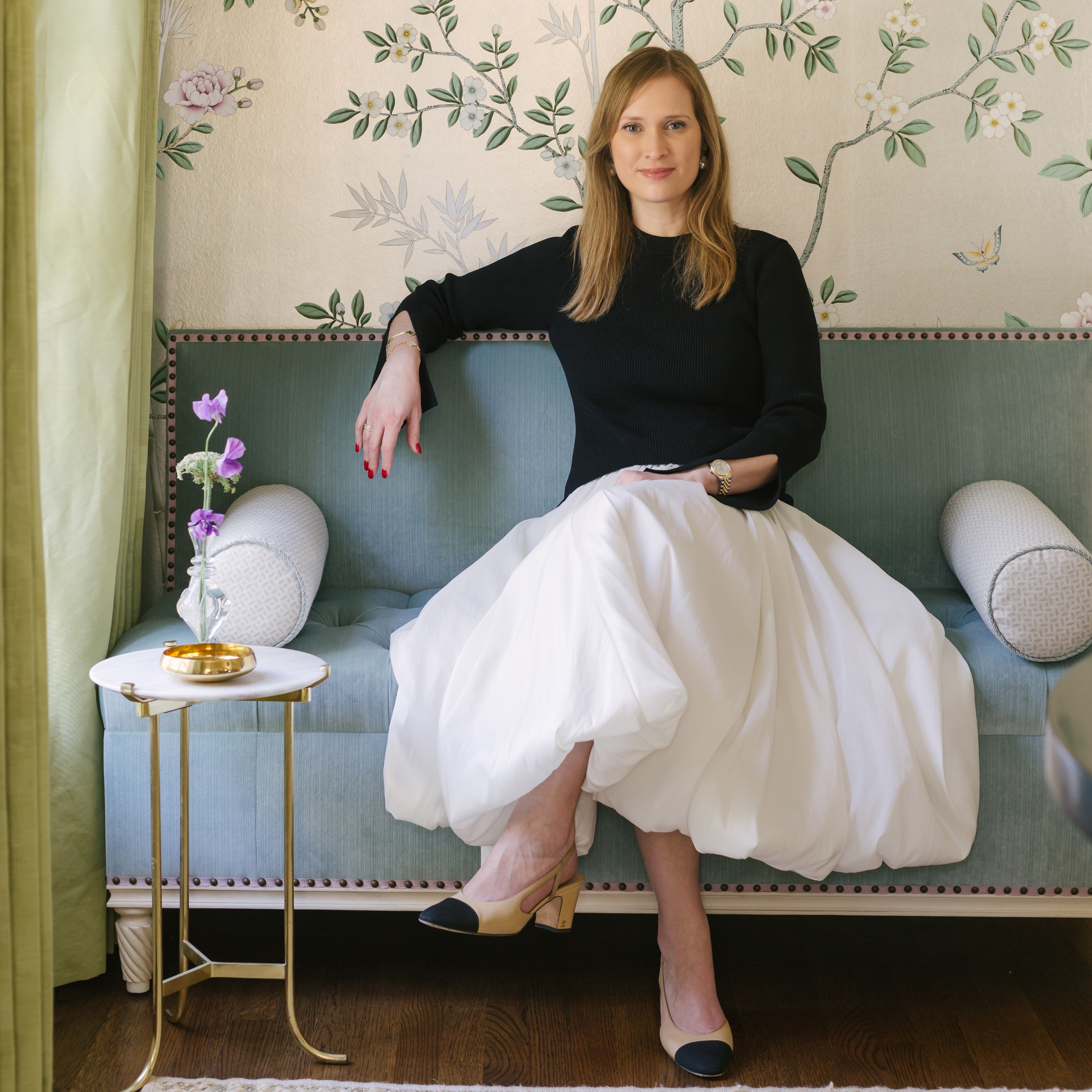 a woman sitting on a couch in a room