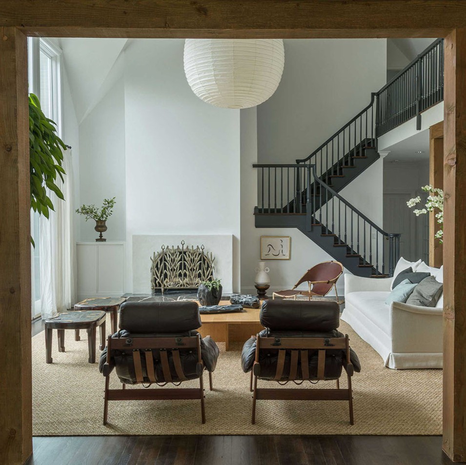 a living room filled with furniture and a staircase