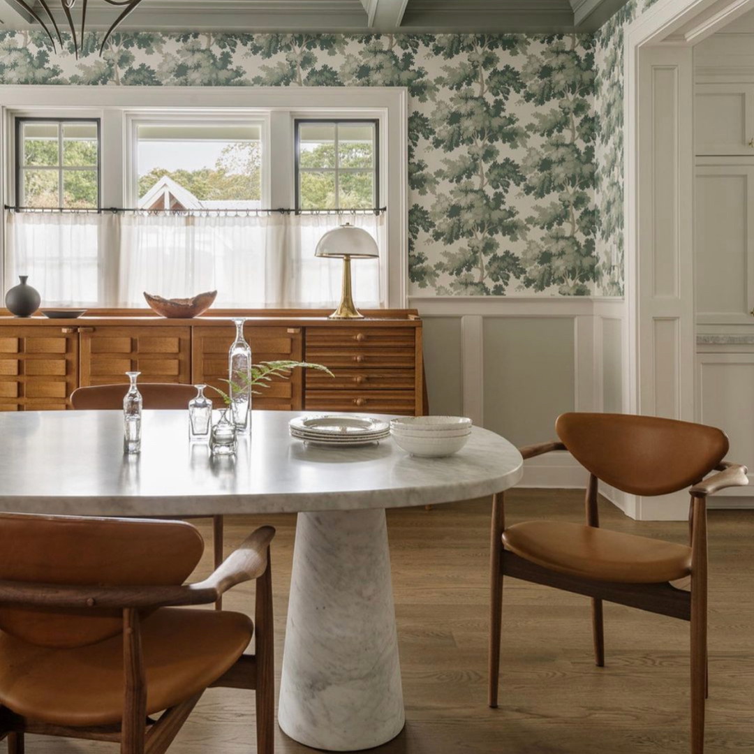 a dining room with a marble table and chairs