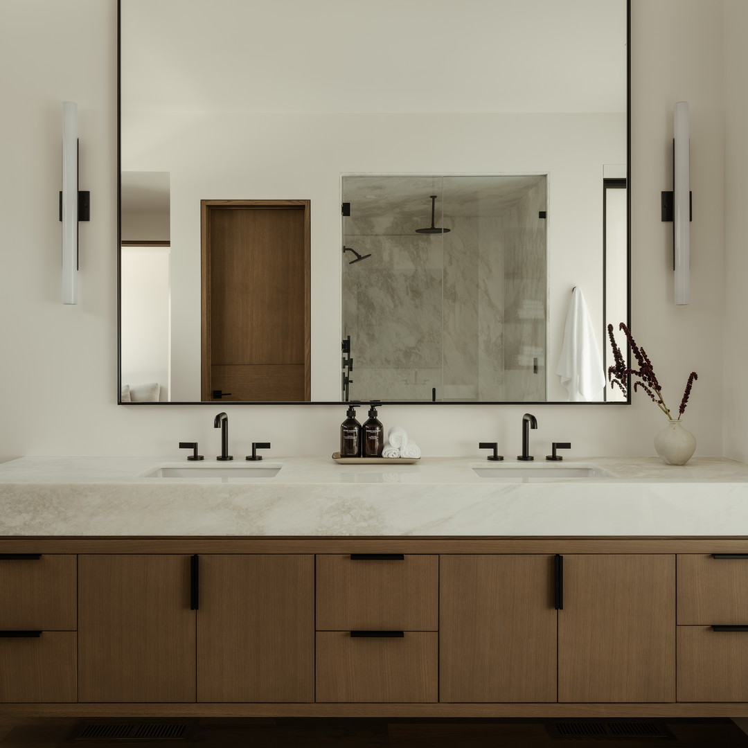 a bathroom with two sinks and a large mirror