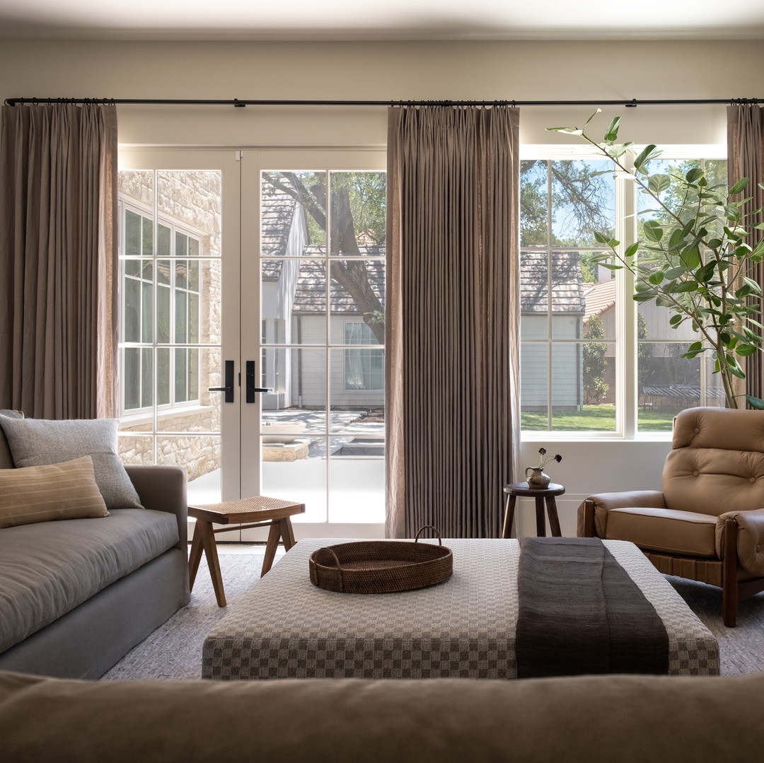 a living room filled with furniture and a large window