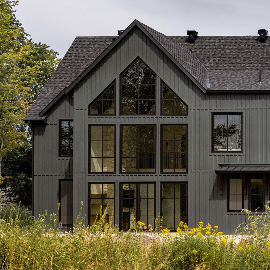 a large gray house with lots of windows