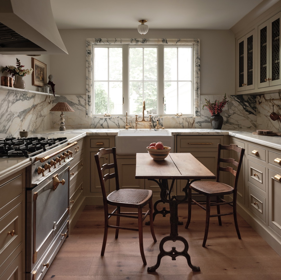 a kitchen with a table and chairs in it