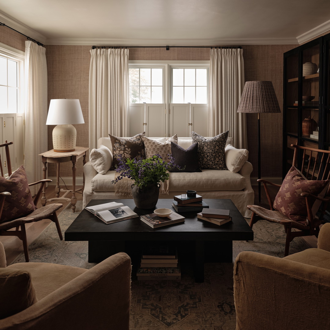 a living room filled with furniture and a lamp