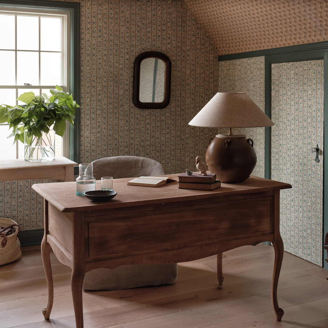 a room with a desk and a lamp