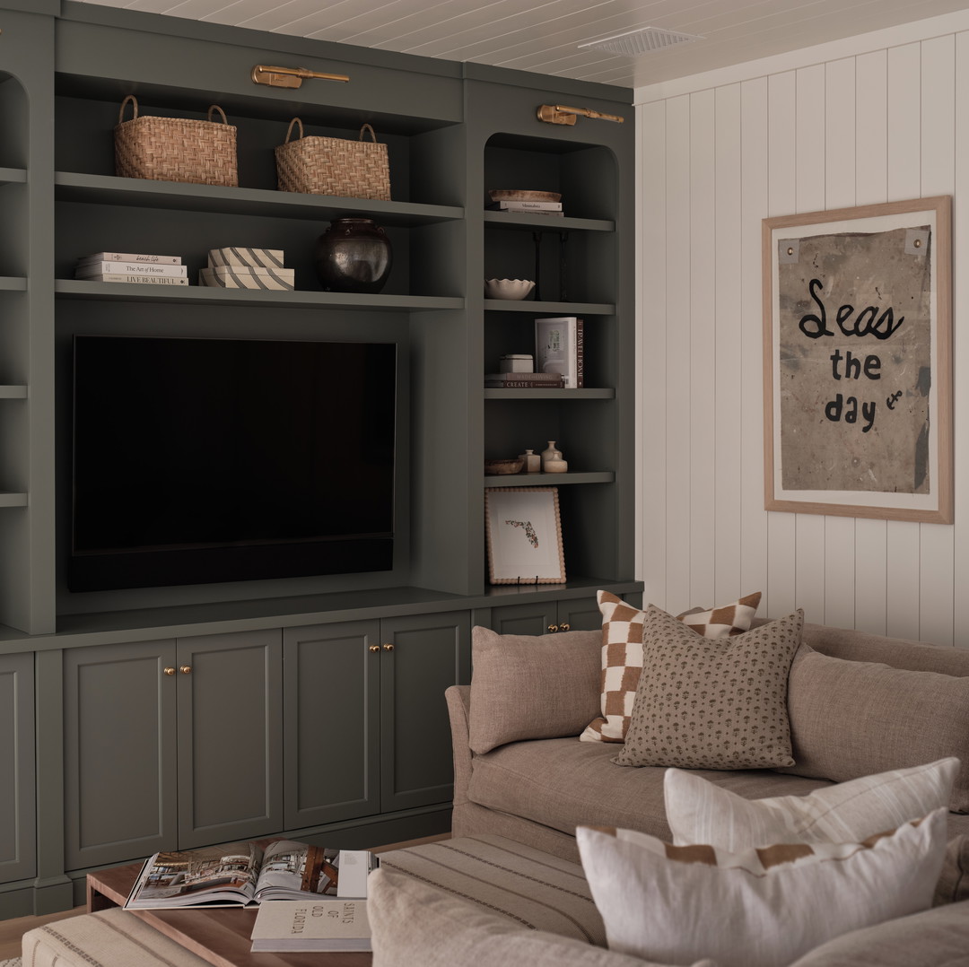 a living room filled with furniture and a flat screen tv