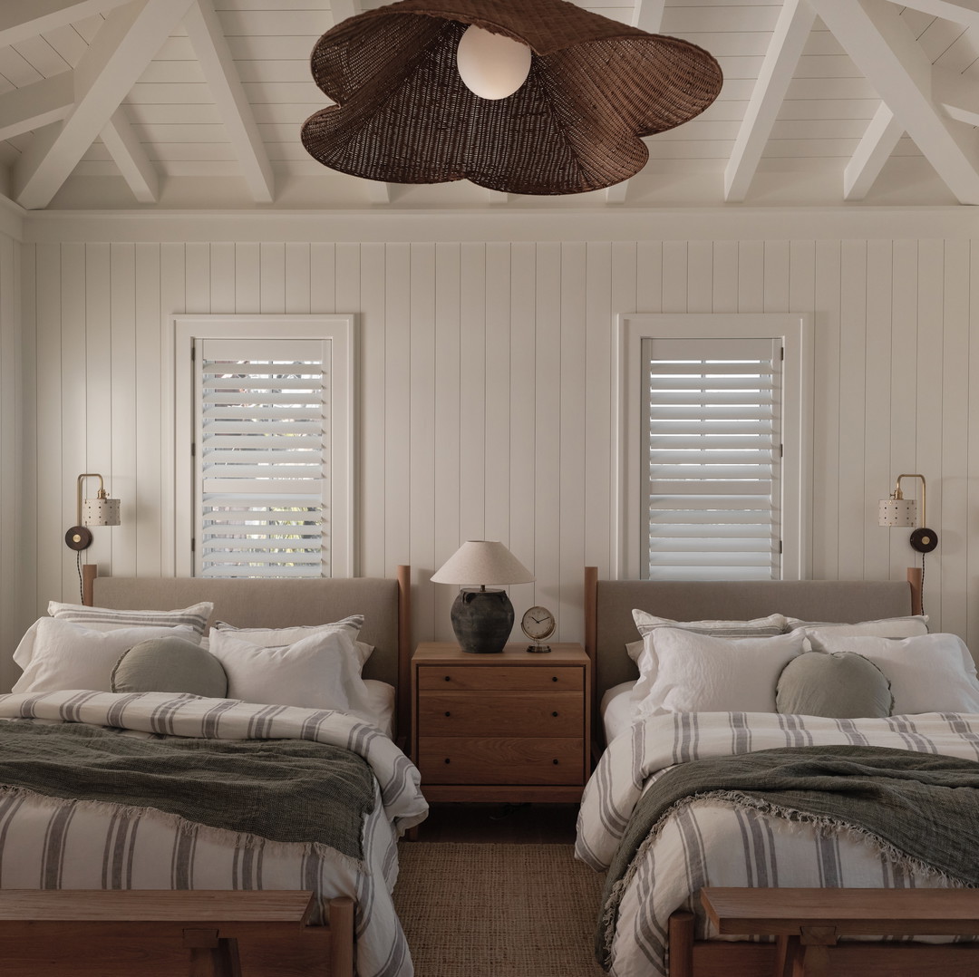 a couple of beds sitting next to each other in a bedroom