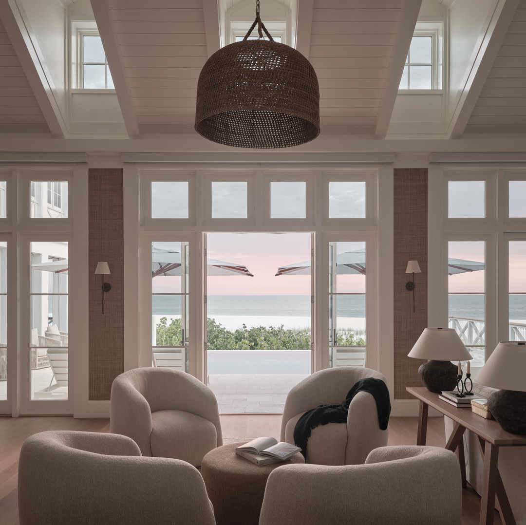 a living room filled with furniture and a large window