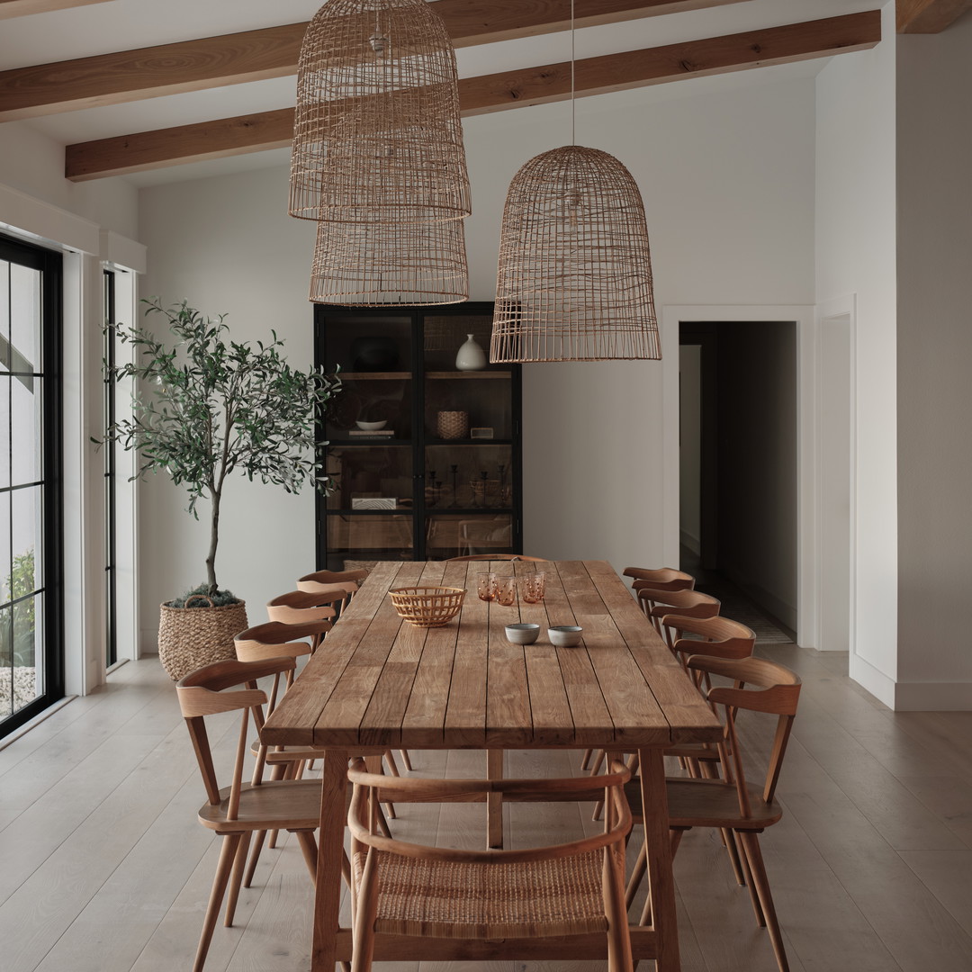 a dining room with a wooden table and chairs