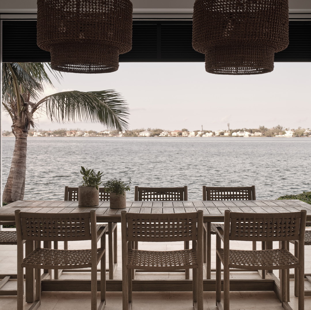a table and chairs with a view of a body of water