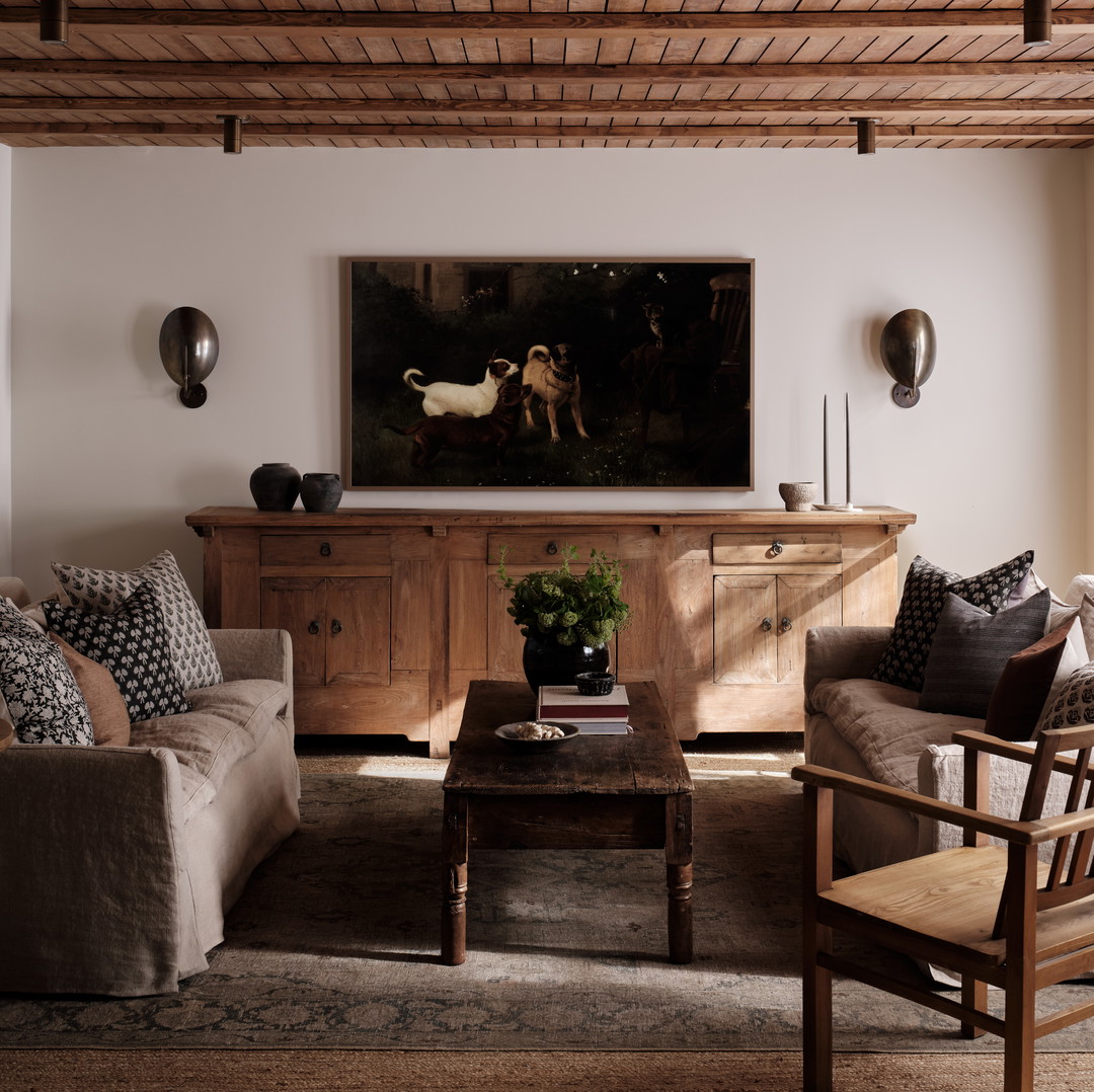 a living room filled with furniture and a painting on the wall