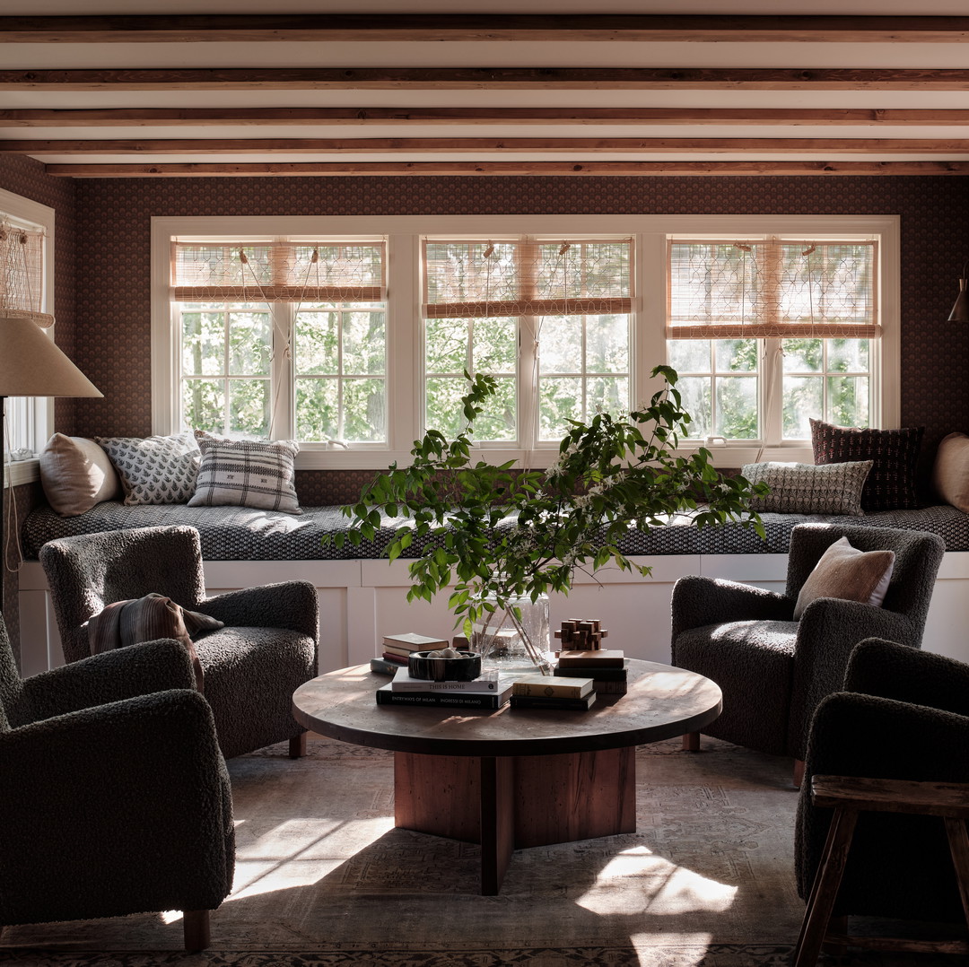 a living room filled with furniture and windows