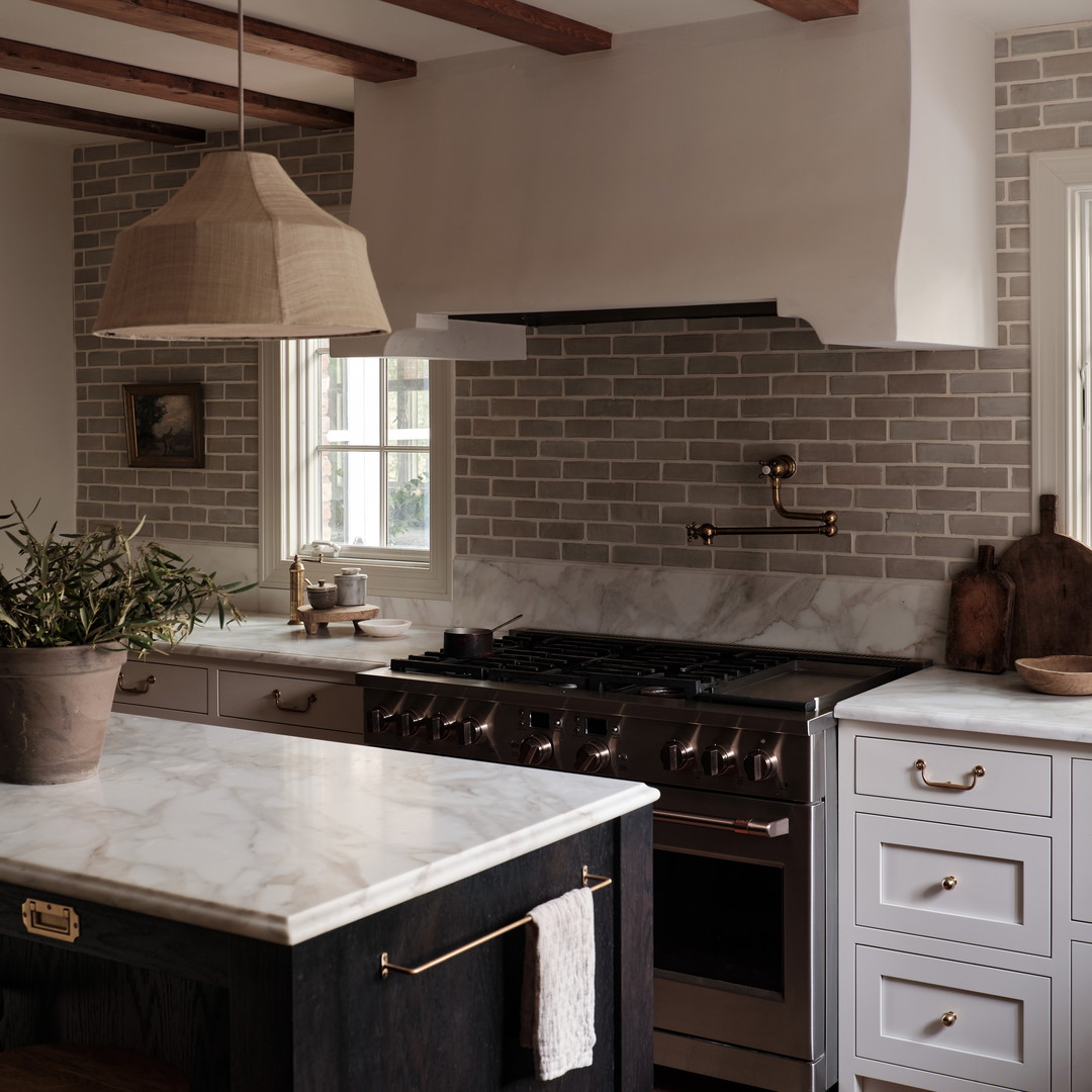 a kitchen with a stove top oven and a potted plant