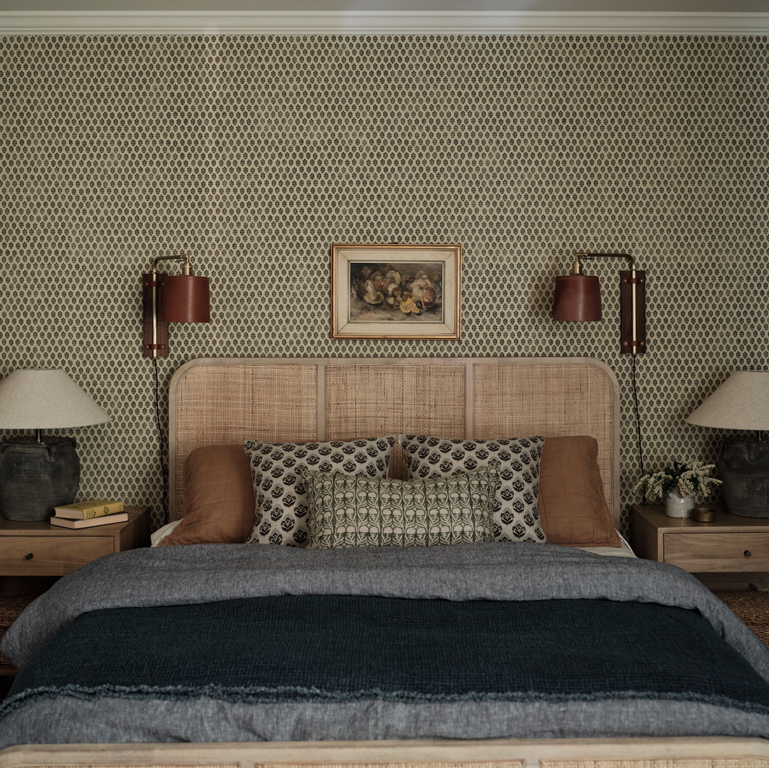 a bedroom with a bed, nightstands and a painting on the wall