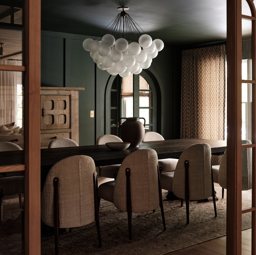 a dining room with a table and chairs