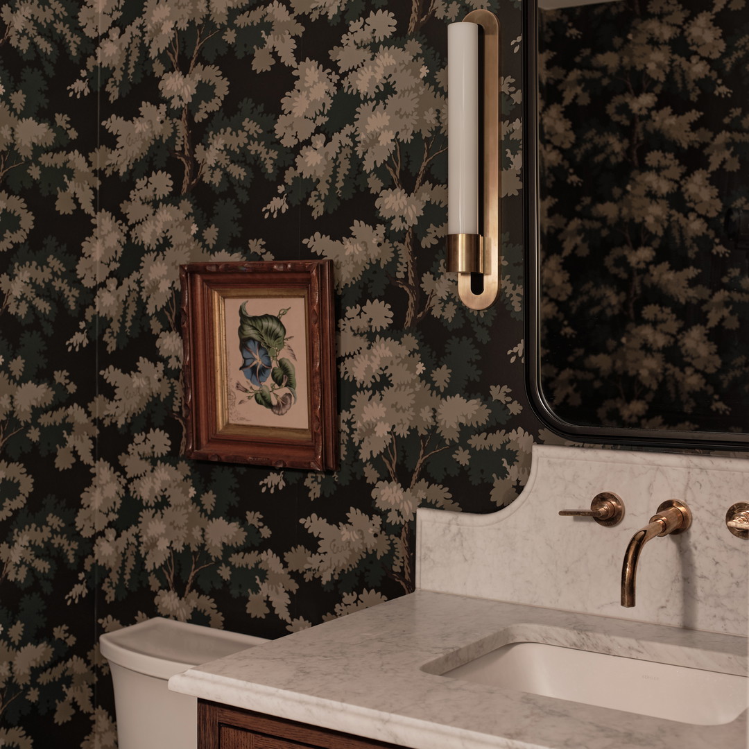 a bathroom with a toilet, sink, and mirror