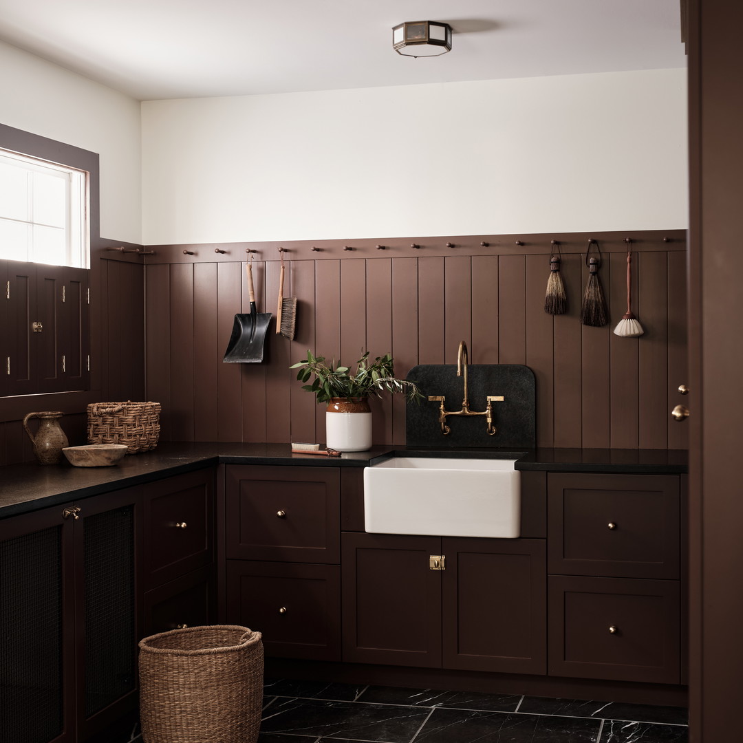 a kitchen with brown cabinets and a white sink