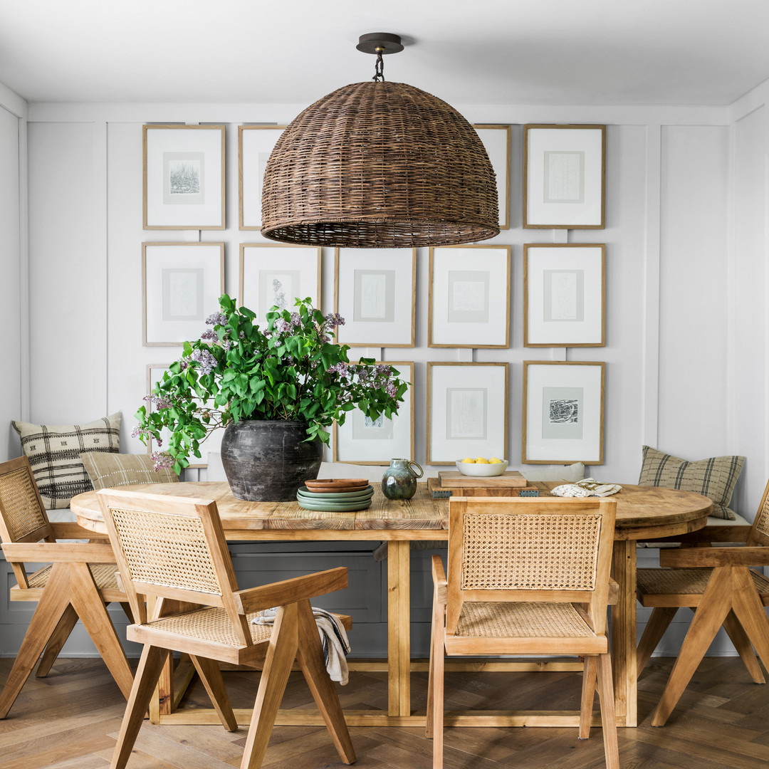 a dining room table with chairs and a potted plant