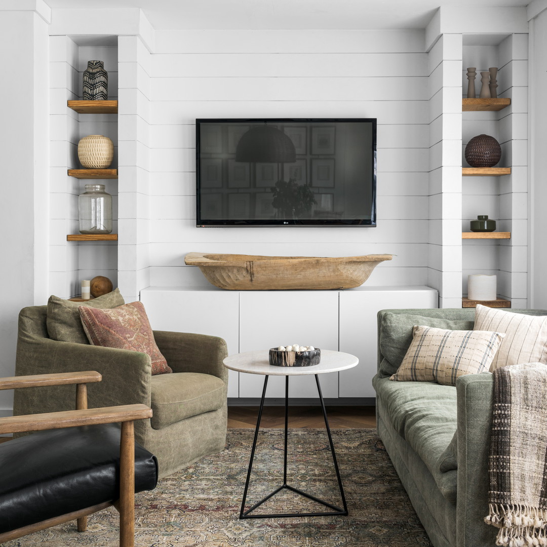 a living room filled with furniture and a flat screen tv