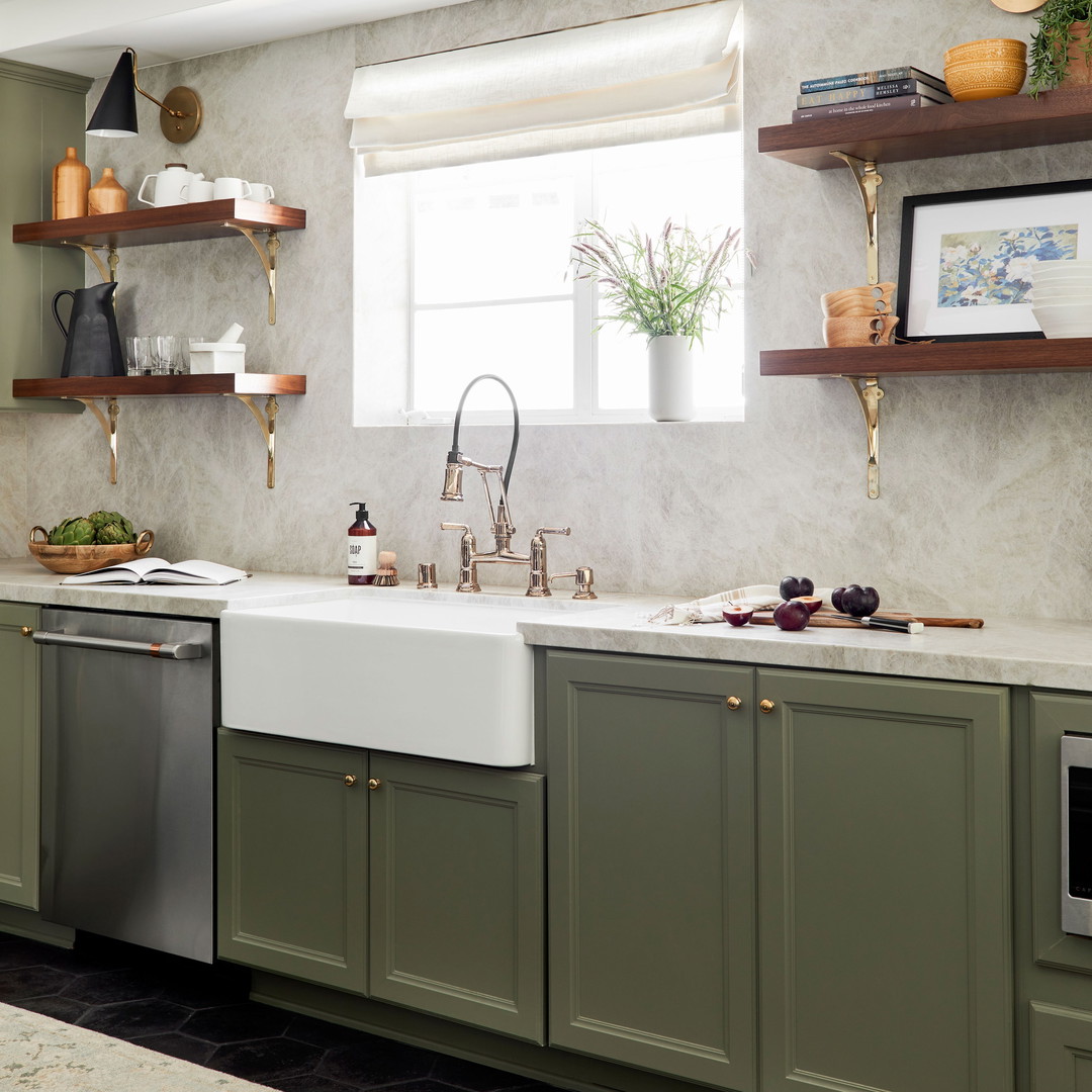 a kitchen with green cabinets and a white sink