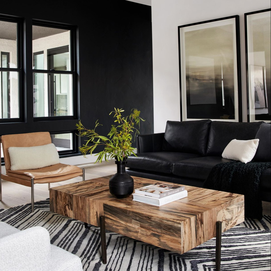 a living room with black walls and white furniture